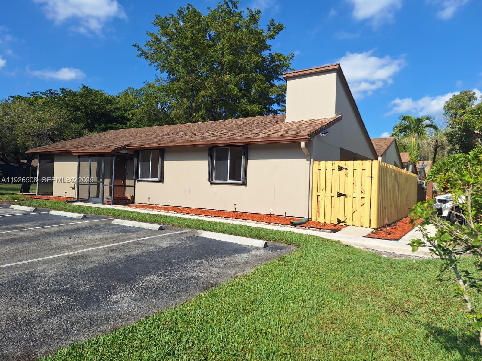 22295 Timberly Drive, Unit 22295 Boca Raton, FL 33428 - Photo 47 of 68 a view of a house with a yard and garage