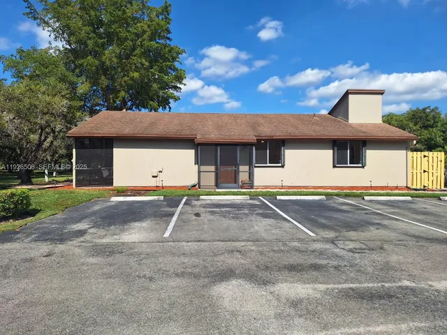 a swimming pool with outdoor seating and yard