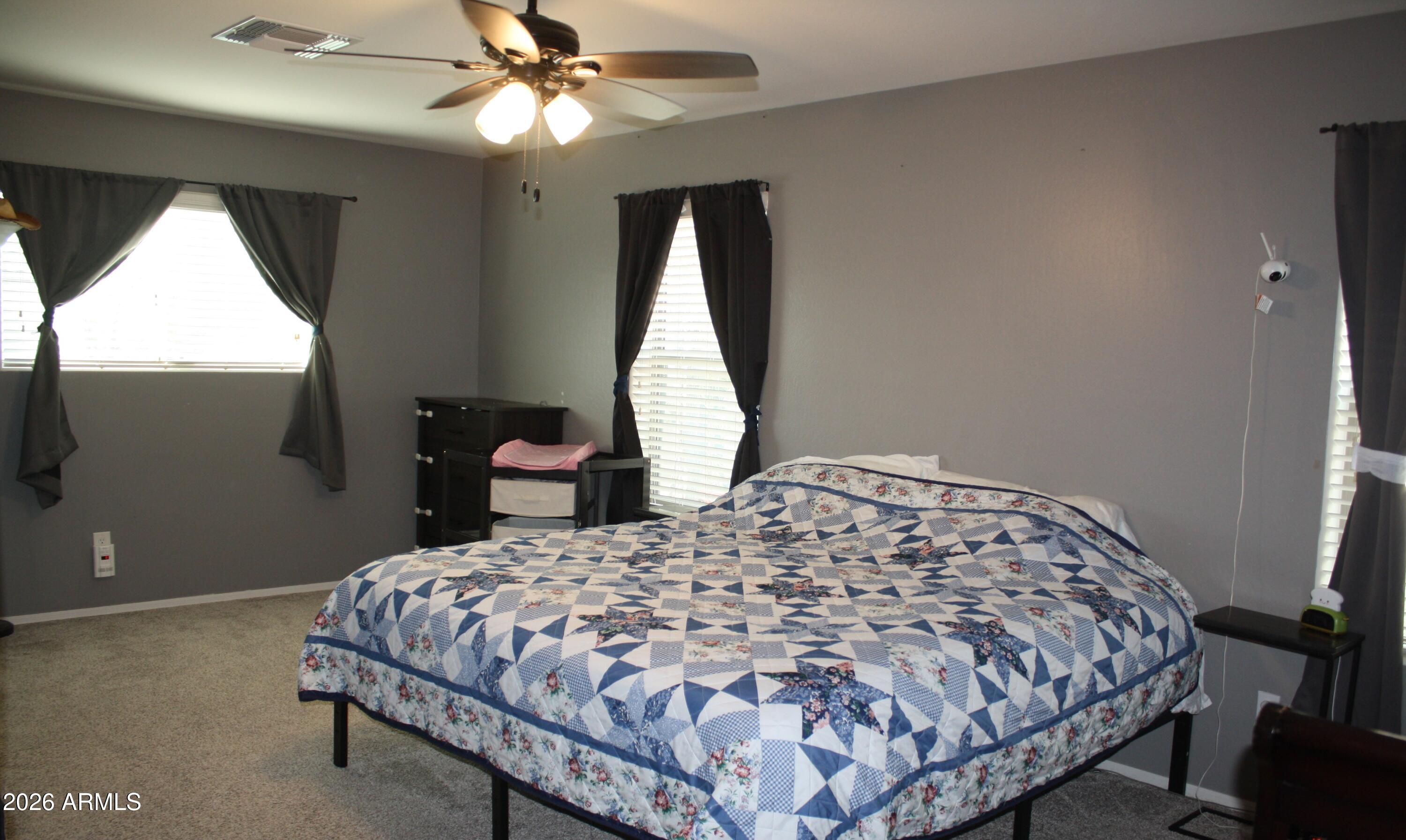 10225 West Camelback Road, Unit 19 Phoenix, AZ 85037 - Photo 33 of 51 a bedroom with a bed and a window