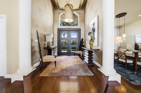 a living room with furniture and a floor to ceiling window