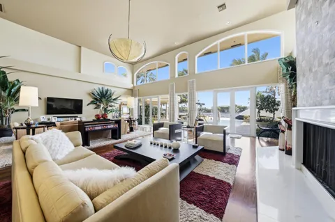 a bed sitting in a bedroom next to a large window