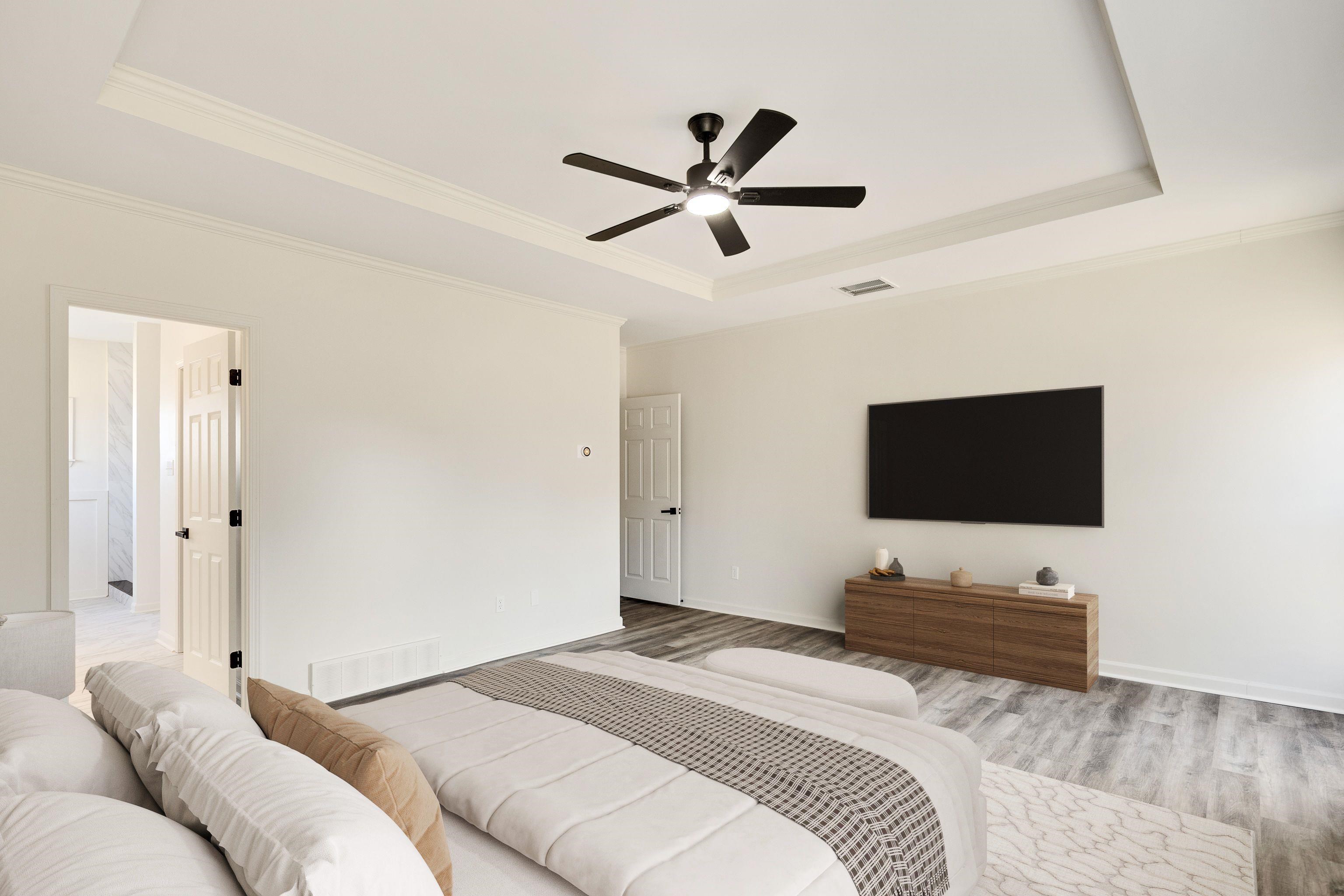 939 Fallen Oaks Drive Collierville, TN 38017 - Photo 13 of 23 a bedroom with a bed and a flat screen tv