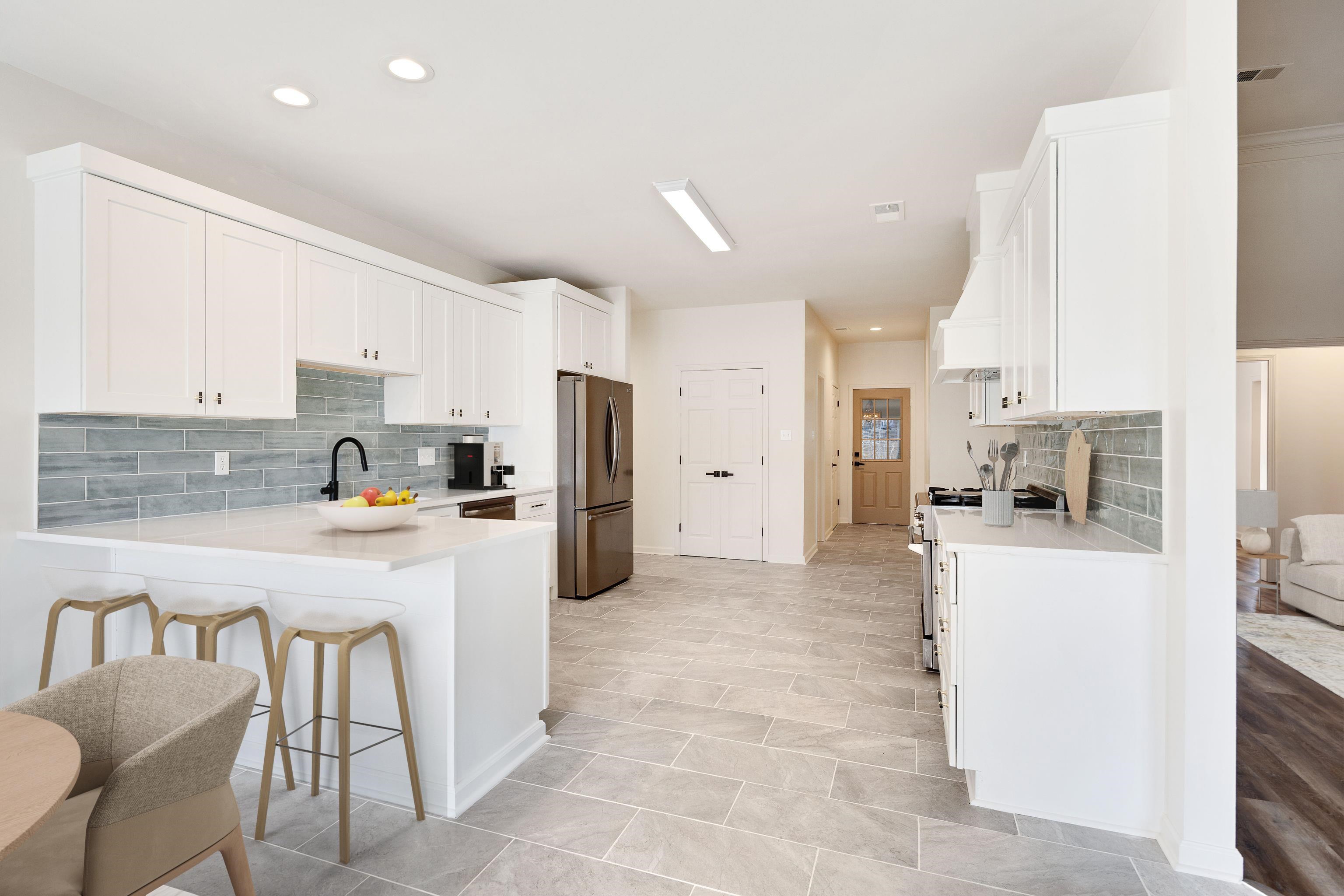 939 Fallen Oaks Drive Collierville, TN 38017 - Photo 9 of 23 a kitchen with stainless steel appliances a refrigerator sink and cabinets