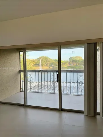 a view of an empty room with a large window