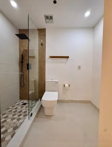a bathroom with a toilet and shower