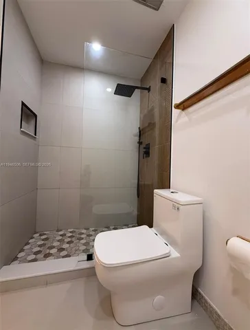 a white toilet sitting next to a bathroom sink