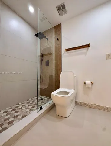 a bathroom with a toilet sink and shower