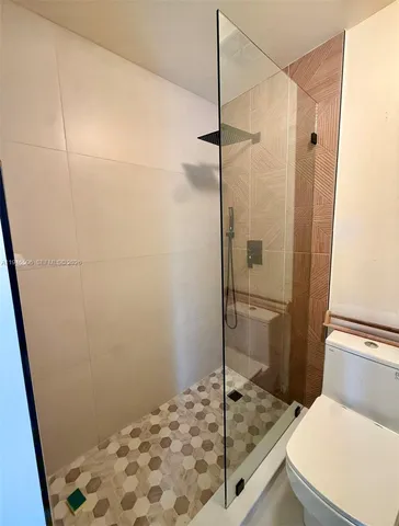 a bathroom with a shower and a sink