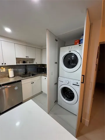 a kitchen with a washer and dryer