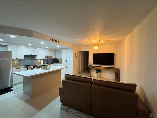 a kitchen with a sink and a refrigerator