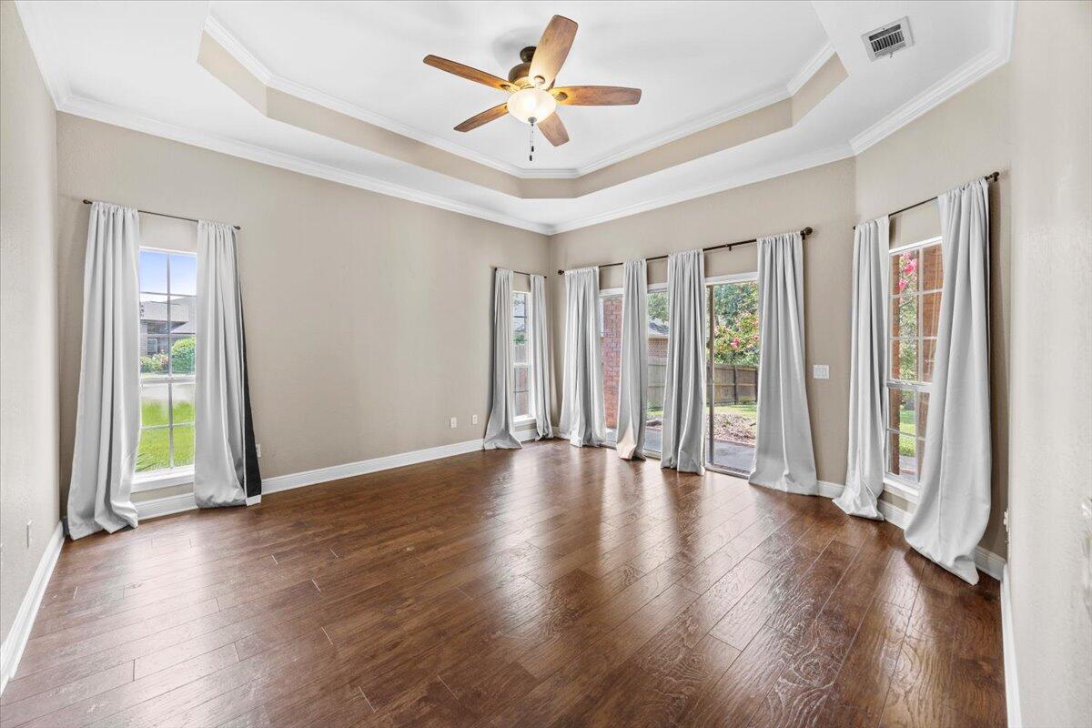 2691 Stormy Circle Navarre, FL 32566 - Photo 13 of 47 a view of an empty room with a window and wooden floor