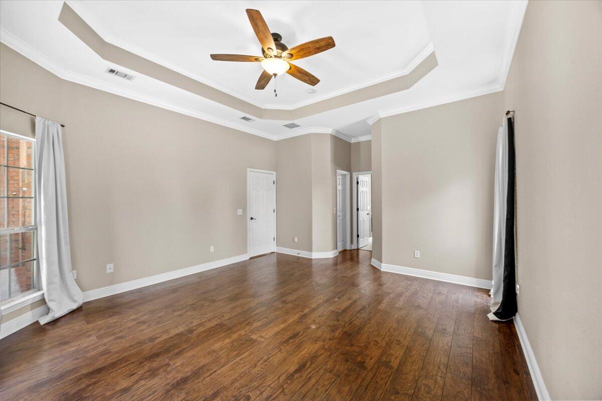 2691 Stormy Circle Navarre, FL 32566 - Photo 14 of 47 wooden floor in an empty room with a window