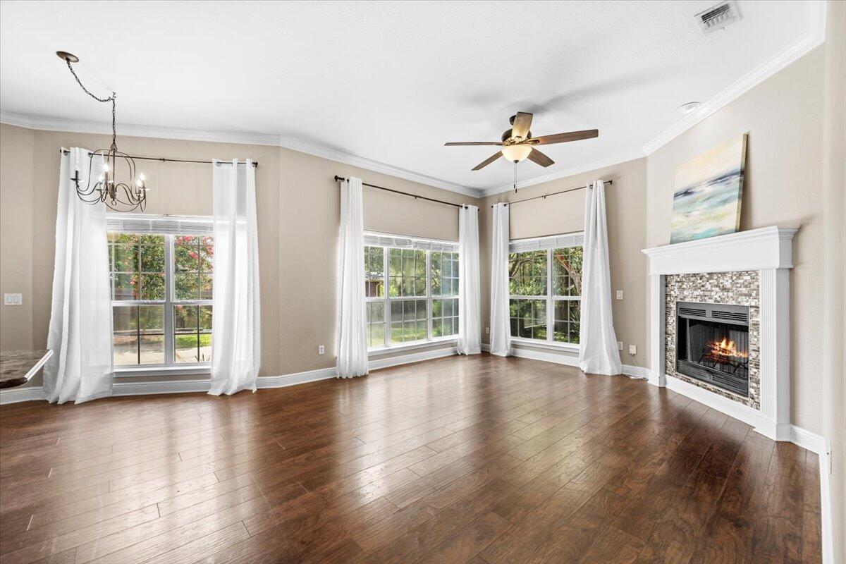 2691 Stormy Circle Navarre, FL 32566 - Photo 17 of 47 a view of an empty room with wooden floor fireplace and a window