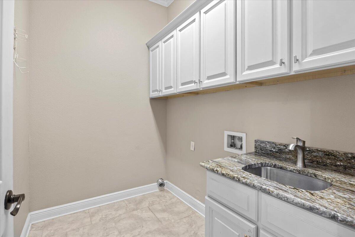 2691 Stormy Circle Navarre, FL 32566 - Photo 25 of 47 a kitchen with granite countertop white cabinets and a sink