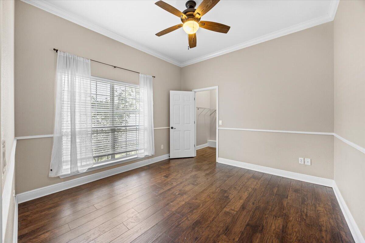2691 Stormy Circle Navarre, FL 32566 - Photo 26 of 47 wooden floor in an empty room with a window