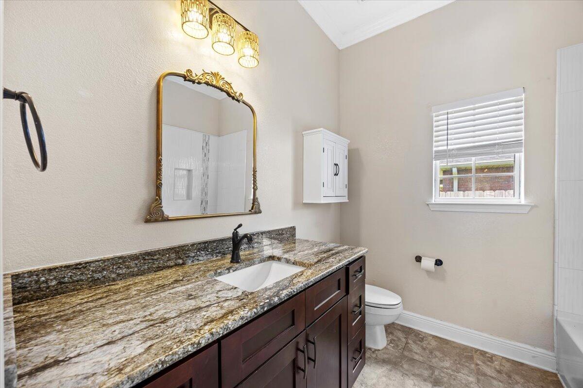 2691 Stormy Circle Navarre, FL 32566 - Photo 27 of 47 a bathroom with a granite countertop sink a toilet and a mirror