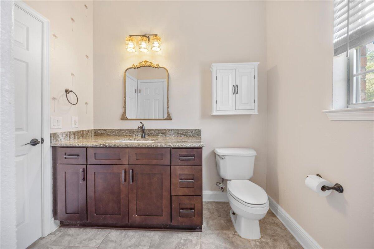 2691 Stormy Circle Navarre, FL 32566 - Photo 29 of 47 a bathroom with a toilet a sink and mirror