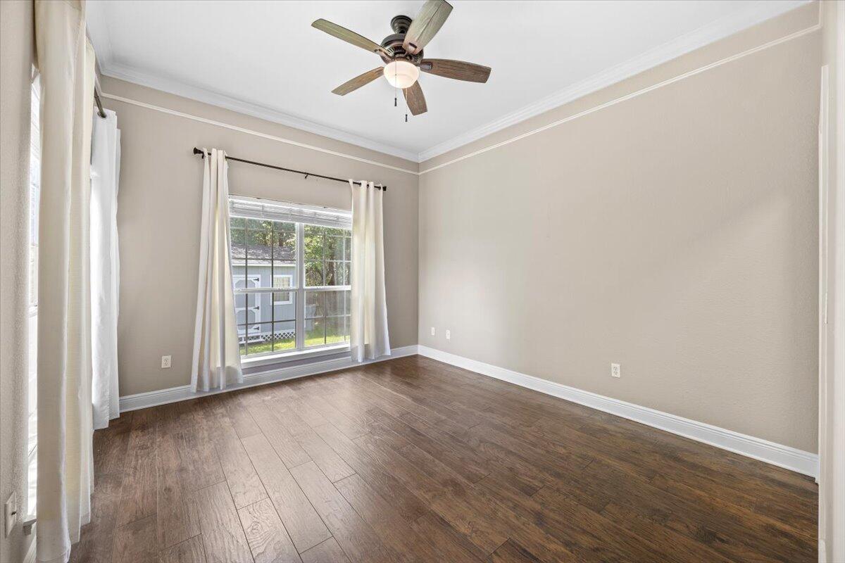 2691 Stormy Circle Navarre, FL 32566 - Photo 30 of 47 an empty room with wooden floor fan and windows