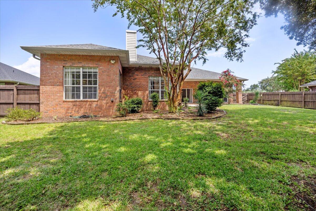 2691 Stormy Circle Navarre, FL 32566 - Photo 32 of 47 a front view of a house with garden