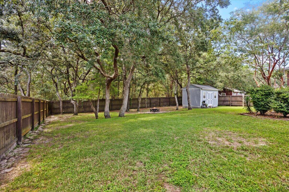 2691 Stormy Circle Navarre, FL 32566 - Photo 33 of 47 a backyard of a house with trees and entertaining space