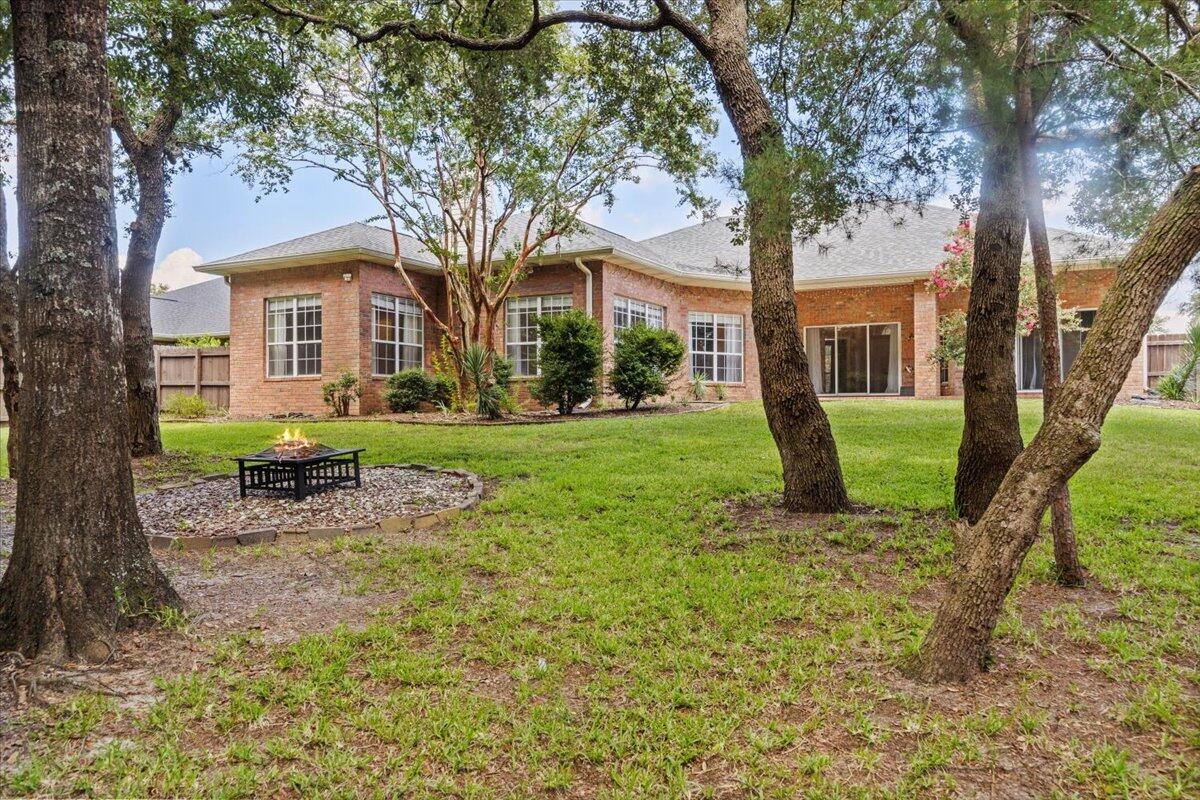 2691 Stormy Circle Navarre, FL 32566 - Photo 35 of 47 a view of a yard in front of a house with a large tree