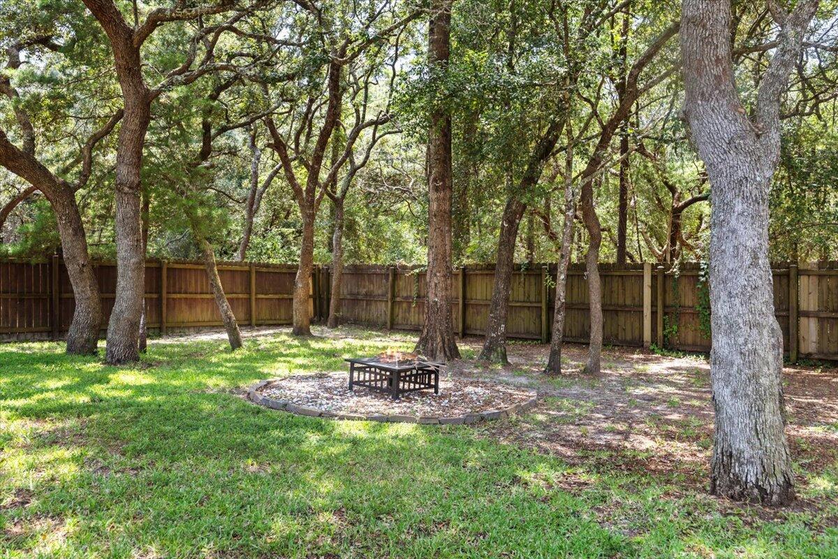 2691 Stormy Circle Navarre, FL 32566 - Photo 36 of 47 a backyard of a house with table and chairs