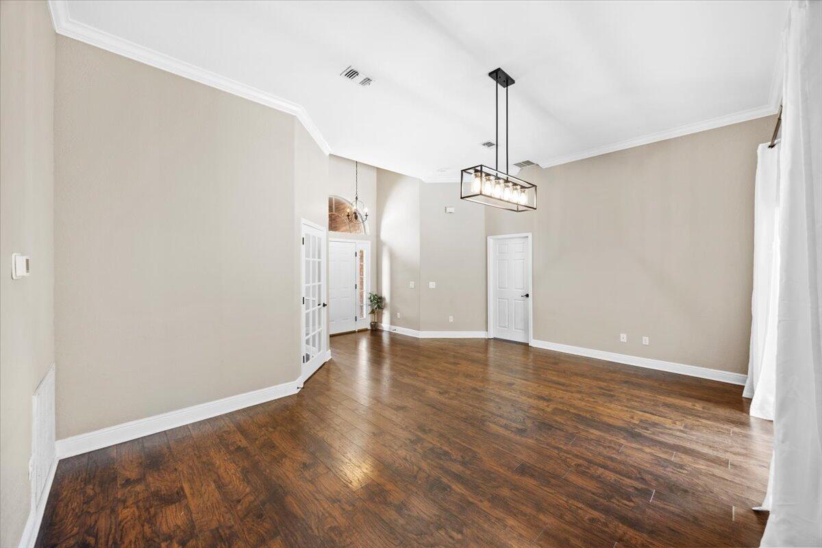 2691 Stormy Circle Navarre, FL 32566 - Photo 7 of 47 a view of a room with wooden floor entryway and a ceiling fan