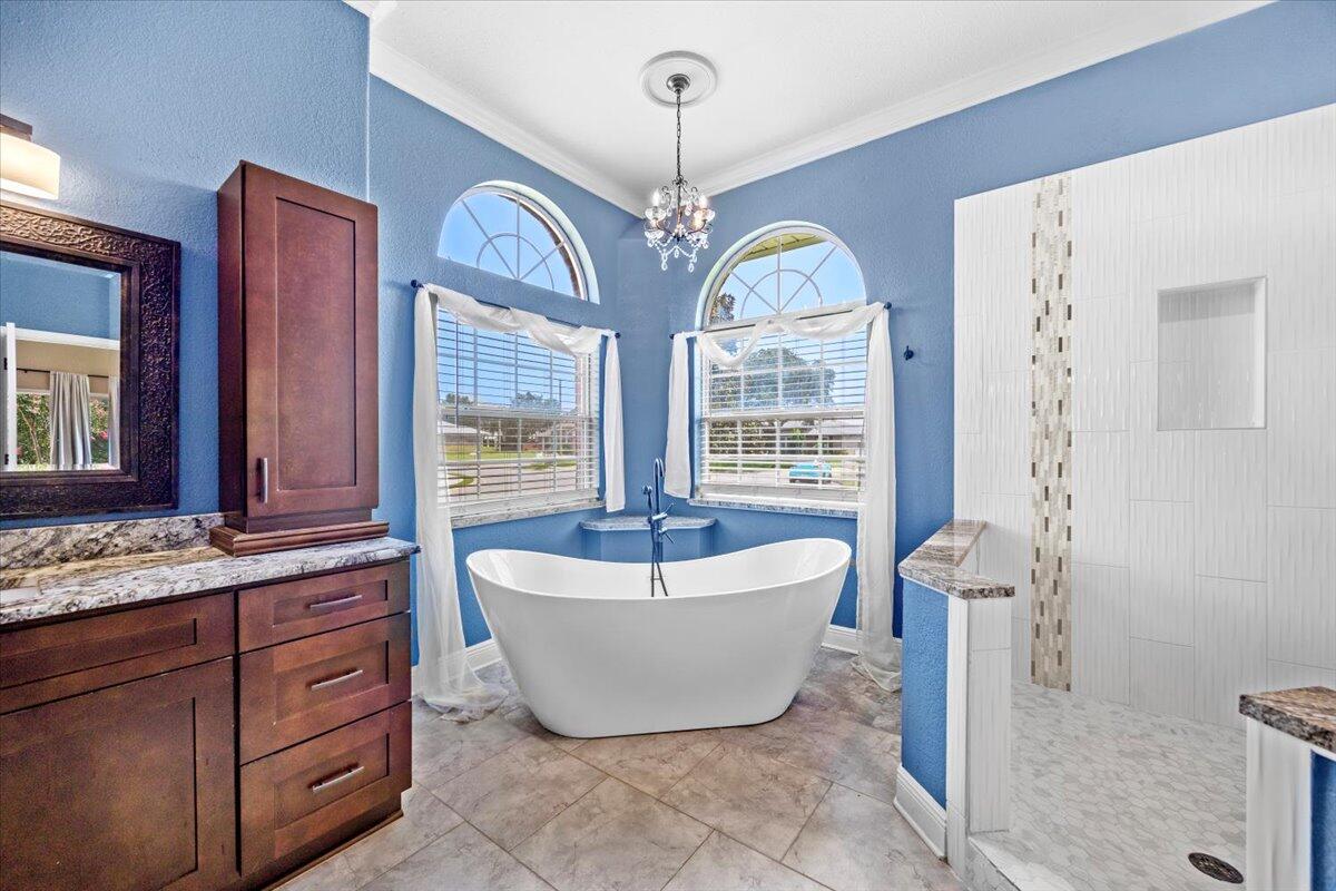 2691 Stormy Circle Navarre, FL 32566 - Photo 9 of 47 a spacious bathroom with a bathtub and window