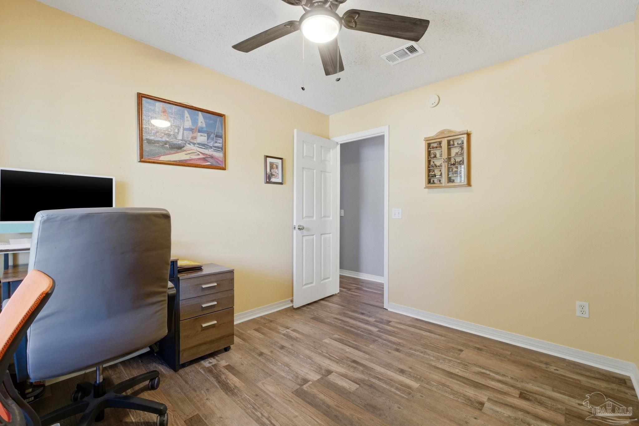 5121 Keyser Mill Road Baker, FL 32531 - Photo 27 of 52 a view of workspace with wooden floor and ceiling fan