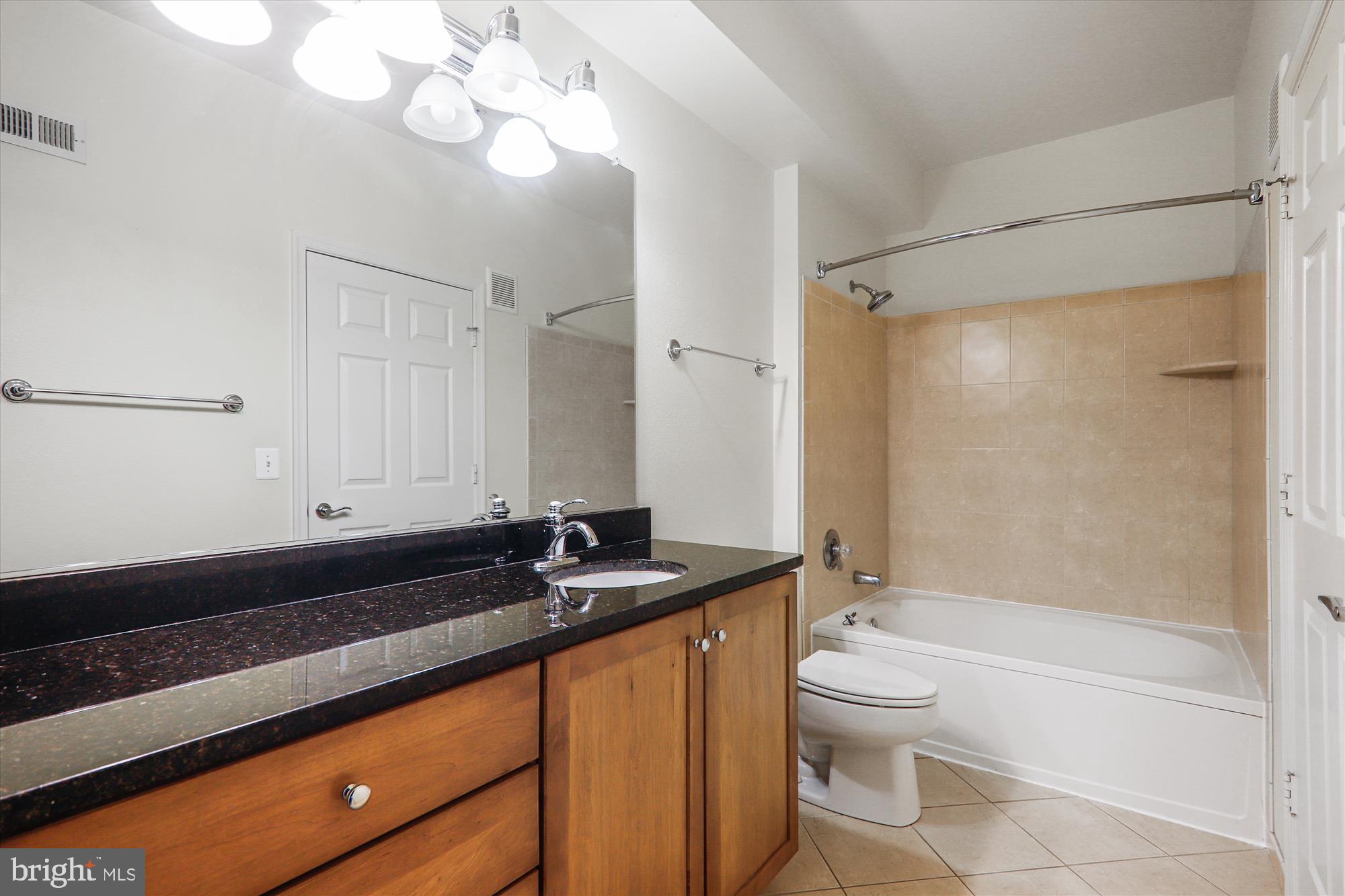 11800 Old Georgetown Road, Unit 1424 Rockville, MD 20852 - Photo 14 of 34 a bathroom with a granite countertop sink a toilet a mirror and shower