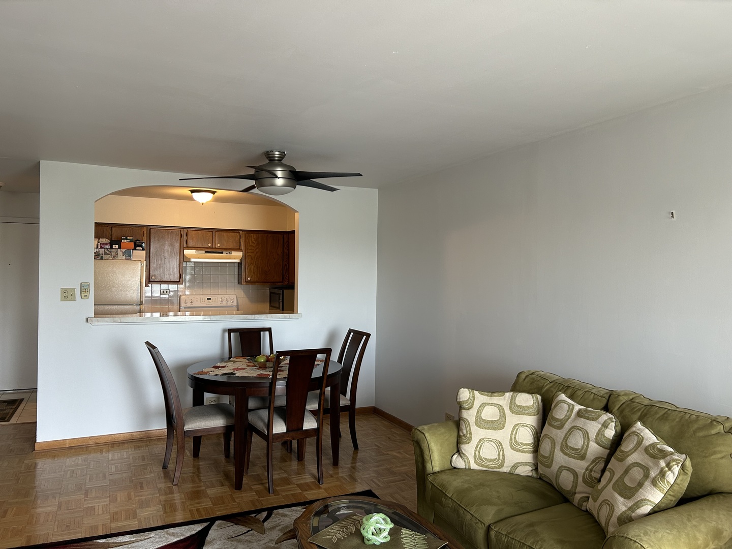 701 West Huntington Commons Road, Unit 410 Mount Prospect, IL 60056 - Photo 6 of 22 a view of a dining room with furniture and wooden floor