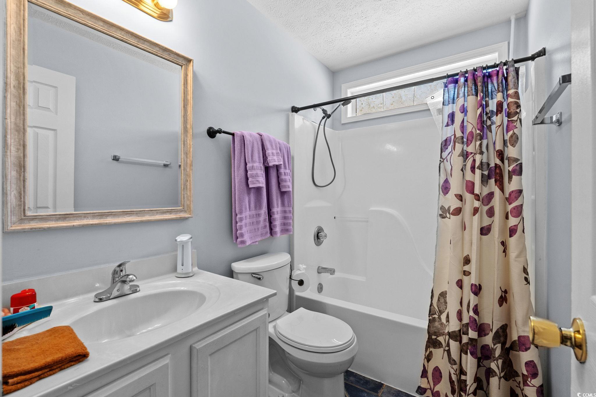 8069 Resin Road Murrells Inlet, SC 29576 - Photo 20 of 40 Full bath featuring shower / tub combo with curtain, vanity, and a textured ceiling