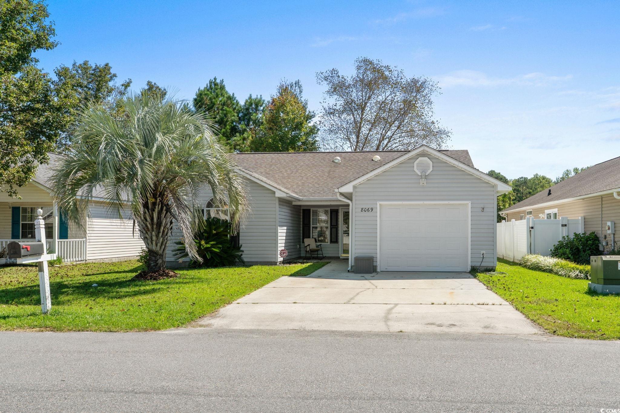 8069 Resin Road Murrells Inlet, SC 29576 - Photo 2 of 40 Ranch-style home featuring concrete driveway, a garage, and roof with shingles