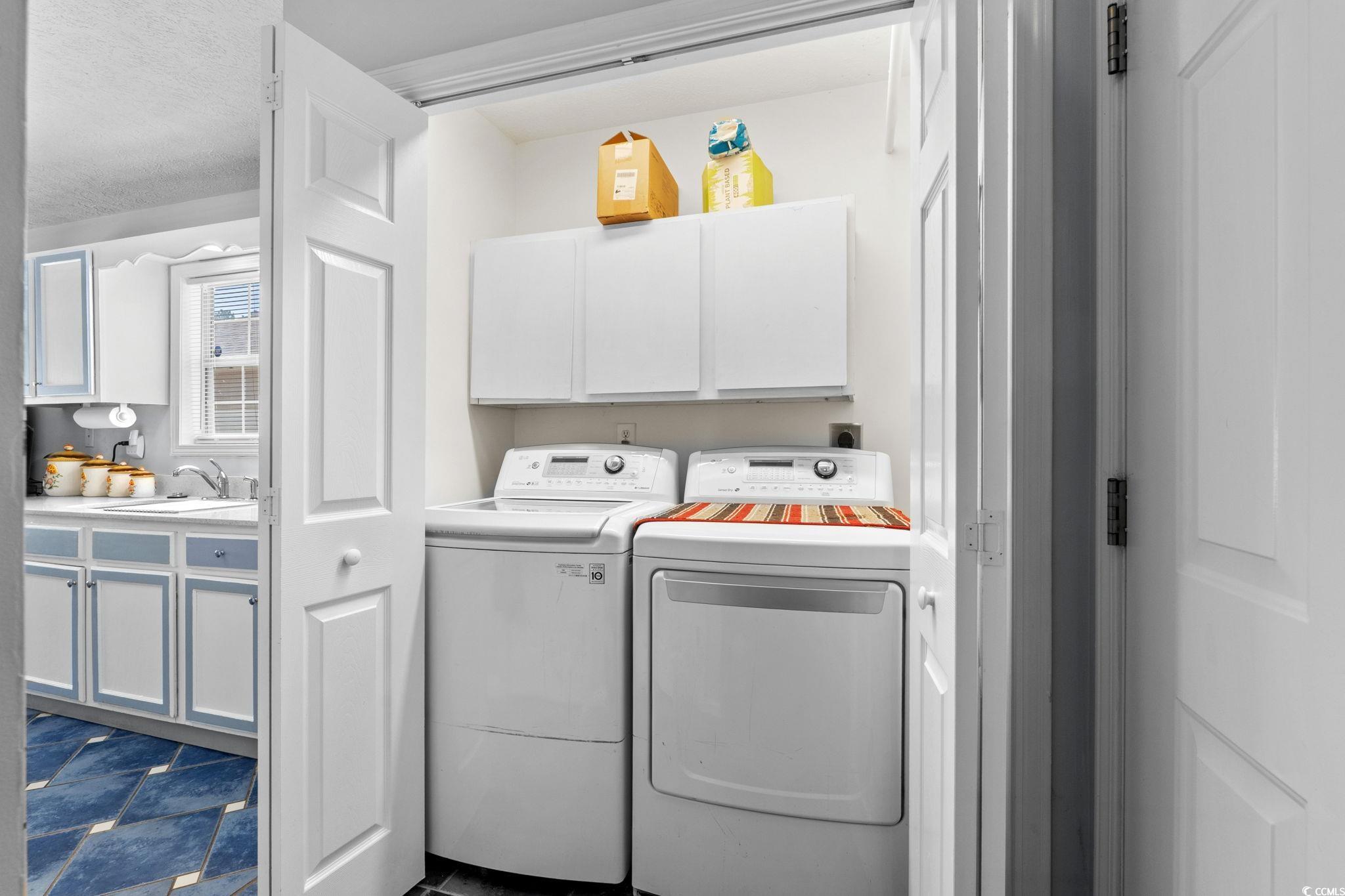 8069 Resin Road Murrells Inlet, SC 29576 - Photo 25 of 40 Laundry area featuring washer and dryer and cabinet space