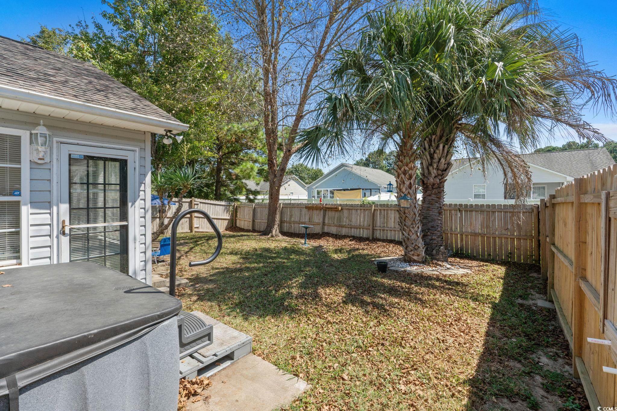 8069 Resin Road Murrells Inlet, SC 29576 - Photo 28 of 40 Fenced backyard featuring a hot tub