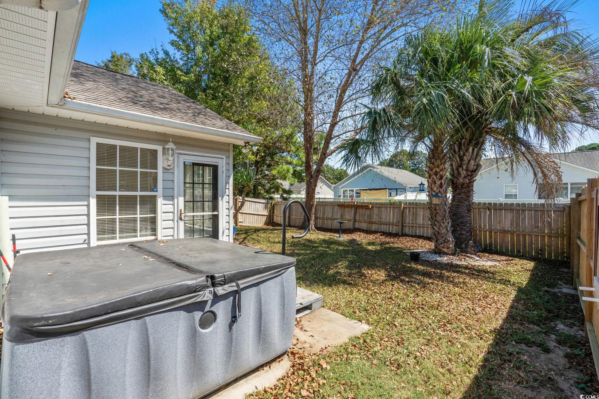 8069 Resin Road Murrells Inlet, SC 29576 - Photo 30 of 40 Fenced backyard featuring a hot tub and a patio area