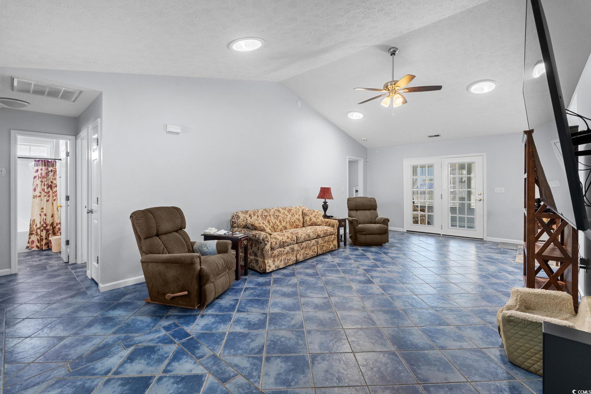 8069 Resin Road Murrells Inlet, SC 29576 - Photo 7 of 40 Living area featuring stairway, vaulted ceiling, a textured ceiling, and ceiling fan