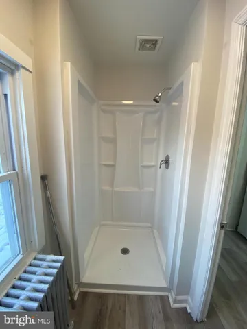 a bathroom with a glass shower door
