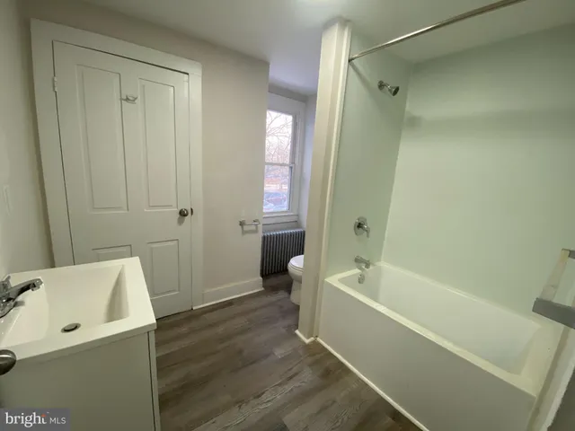 a bathroom with a bathtub a toilet and a sink