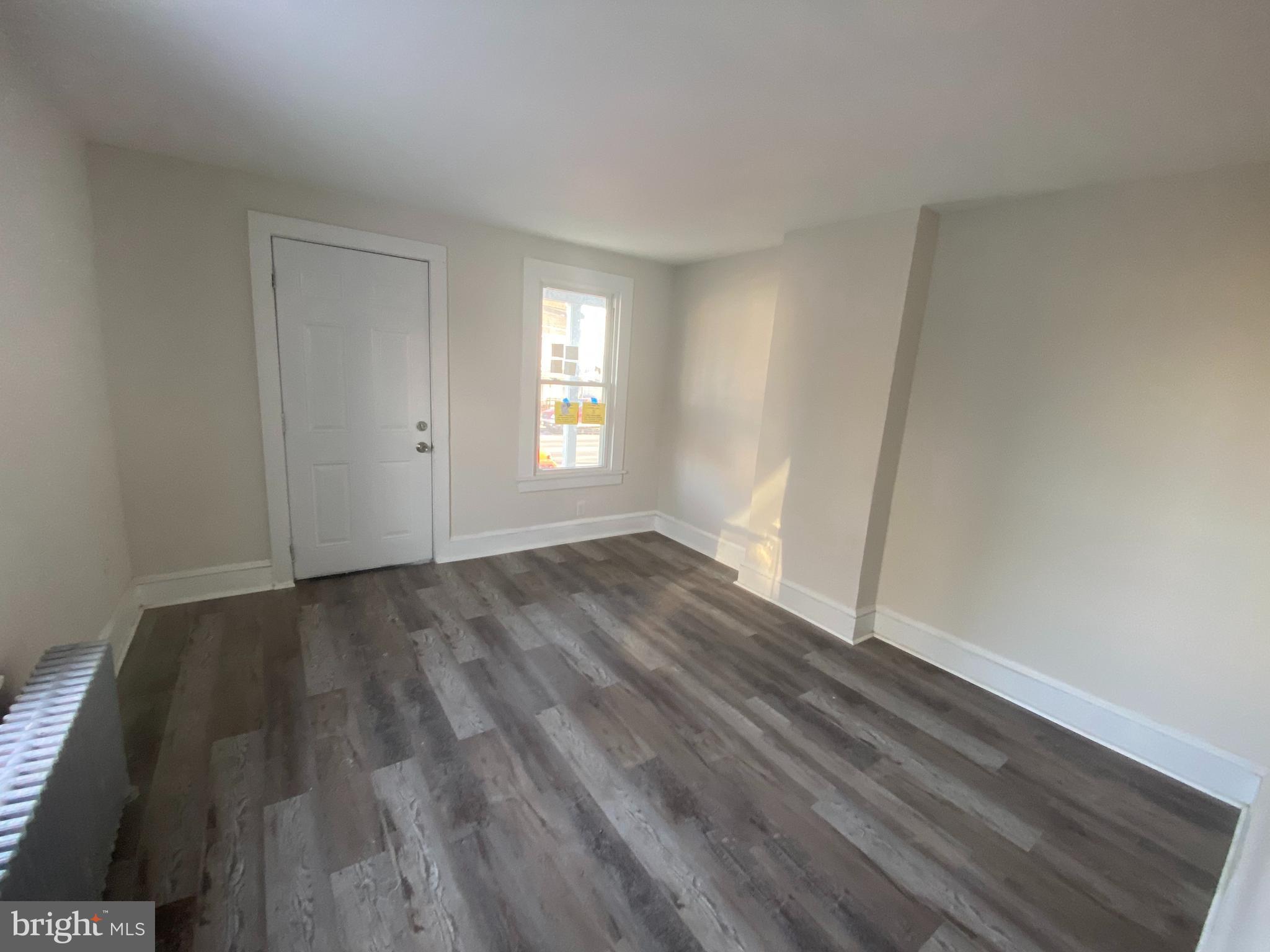 476 North Pearl Street Bridgeton, NJ 08302 - Photo 5 of 18 a view of an empty room with wooden floor and window
