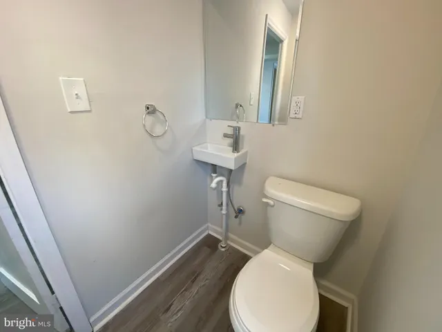 a white toilet sitting next to a bathroom sink