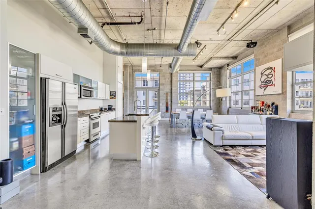 a kitchen with stainless steel appliances granite countertop a stove and cabinets