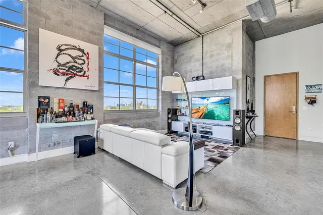 a work room with furniture and a large window