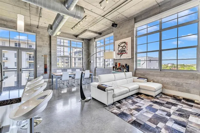 a living room with furniture and a floor to ceiling window