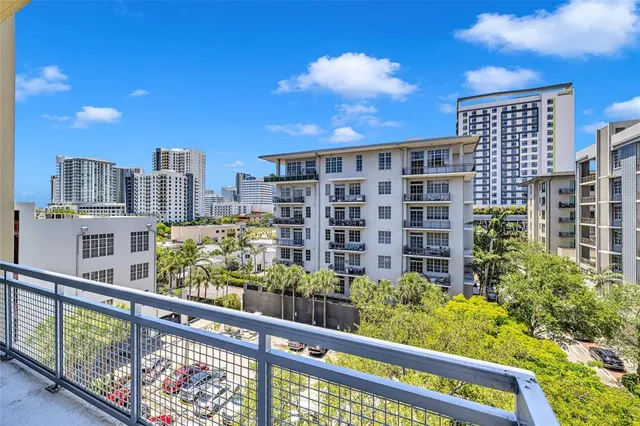 a living room with furniture a clock and a large window