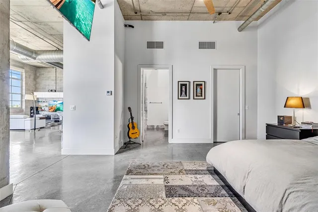 a living room with furniture a flat screen tv and a window