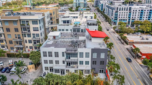 a view of a patio with couches table and chairs with wooden floor