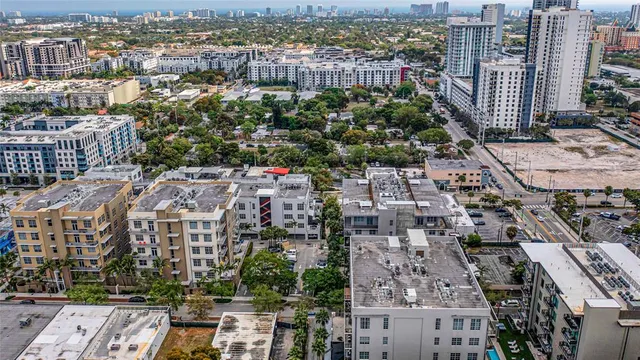 a patio with a table and chairs and potted plants
