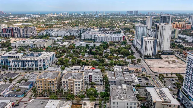 a view of a rooftop with chairs and a table