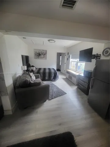 a living room with furniture and a lamp